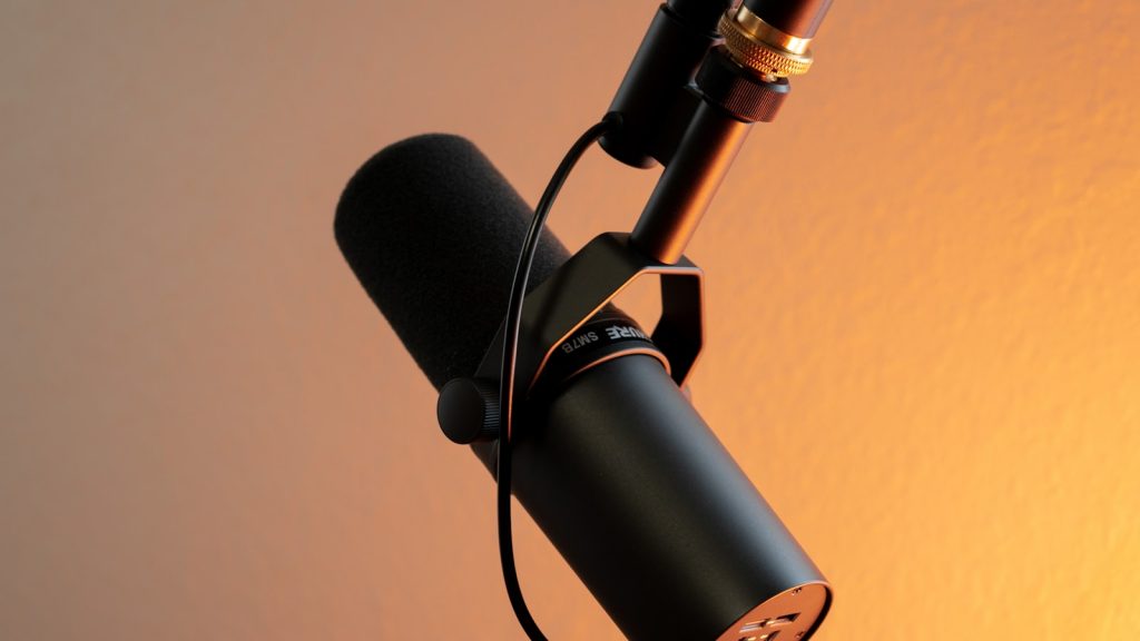 black and silver microphone on brown wall