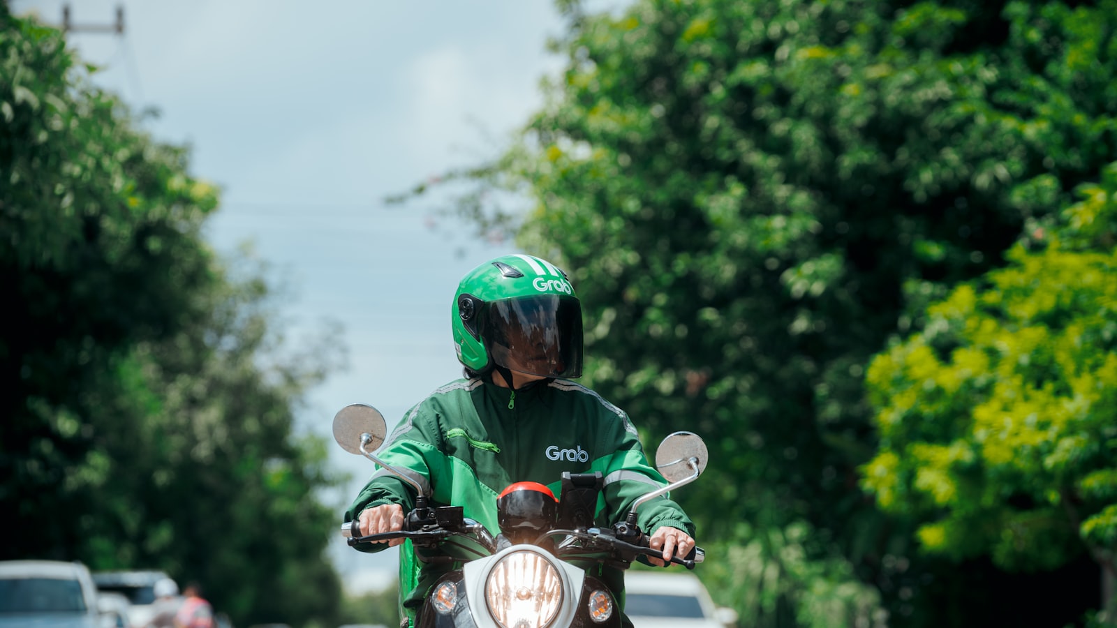 a person riding a motorcycle down a street