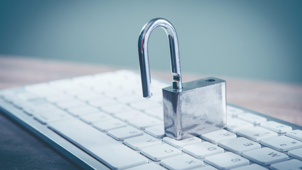 a padlock sitting on top of a computer keyboard