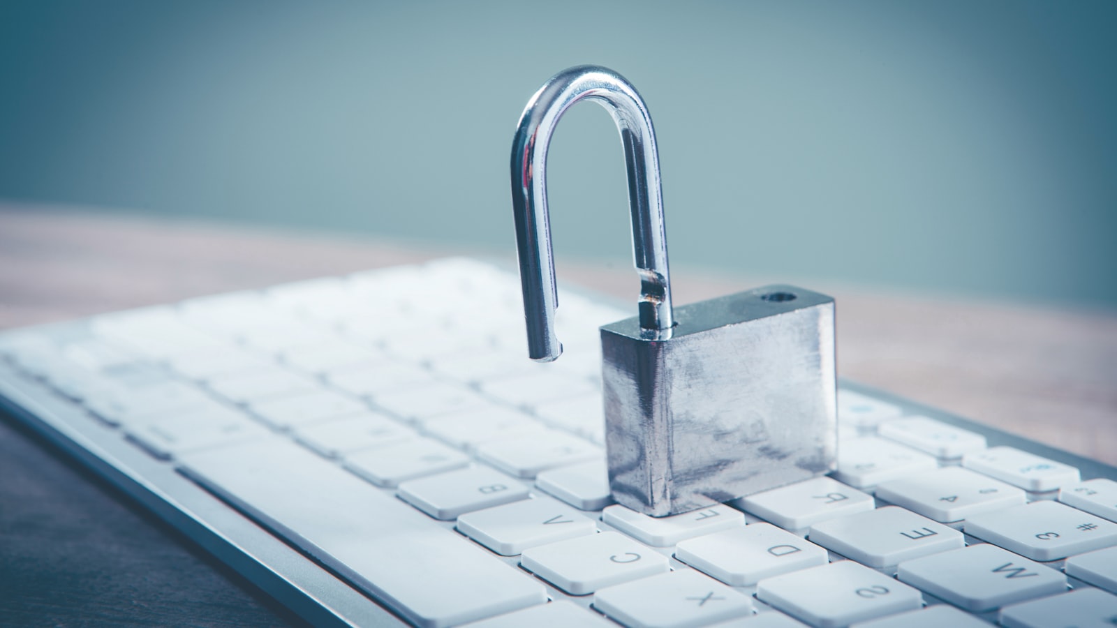 a padlock sitting on top of a computer keyboard